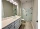 Modern bathroom with white vanity and glass shower at 8592 Hempstead Way, Mount Dora, FL 32757