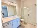 Clean bathroom with white vanity and glass shower at 8592 Hempstead Way, Mount Dora, FL 32757