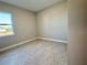 Bright bedroom with a large window and neutral color scheme at 8592 Hempstead Way, Mount Dora, FL 32757