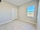 Simple bedroom with double door closet and window at 8592 Hempstead Way, Mount Dora, FL 32757