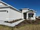 One-story home with gray siding, two-car garage, and a landscaped front yard at 8592 Hempstead Way, Mount Dora, FL 32757