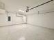 Spacious garage with overhead storage and epoxy floor at 8592 Hempstead Way, Mount Dora, FL 32757