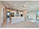 Modern kitchen with a large island open to the dining and Gathering room areas at 8592 Hempstead Way, Mount Dora, FL 32757