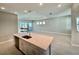 Open concept kitchen and Gathering room with sliding glass doors and natural light at 8592 Hempstead Way, Mount Dora, FL 32757