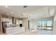 Open floor plan with modern kitchen and Gathering room, leading to a sliding glass door at 8592 Hempstead Way, Mount Dora, FL 32757