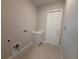 Convenient laundry room with utility sink and cabinets at 8592 Hempstead Way, Mount Dora, FL 32757