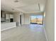 Open living room with sliding glass doors and view of backyard at 8592 Hempstead Way, Mount Dora, FL 32757