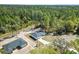 Aerial view of the home and surrounding forest at 91 Locust Loop, Ocala, FL 34472