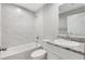 Bathroom with bathtub, tile walls, shower head and stone countertop at 91 Locust Loop, Ocala, FL 34472