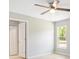 Bedroom with ceiling fan, closet, and window offering natural light at 91 Locust Loop, Ocala, FL 34472