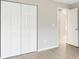 Bedroom featuring wood-look floors and a double door closet at 91 Locust Loop, Ocala, FL 34472