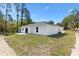 A newly constructed home featuring fresh sod and a concrete patio at 91 Locust Loop, Ocala, FL 34472