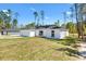 View of a modern single-story home with a two-car garage and well-kept lawn at 91 Locust Loop, Ocala, FL 34472