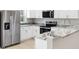Close up of a well-appointed kitchen featuring stainless steel appliances and elegant granite countertops at 91 Locust Loop, Ocala, FL 34472