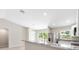 Open layout with bar seating overlooking stainless steel refrigerator and outdoor view at 91 Locust Loop, Ocala, FL 34472