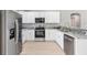 Modern kitchen with stainless steel appliances and white cabinets, complete with stone countertops at 91 Locust Loop, Ocala, FL 34472