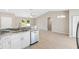Bright kitchen featuring white cabinets, stone countertops and stainless steel appliances at 91 Locust Loop, Ocala, FL 34472