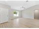 Bright, open-concept living area with wood-look floors and modern ceiling fan, filled with natural light at 91 Locust Loop, Ocala, FL 34472