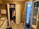 Functional bathroom featuring a double sink vanity, large closet, and walk-in shower at 975 Cr 461, Lake Panasoffkee, FL 33538