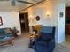 Cozy living room featuring a ceiling fan, comfortable seating, and unique wall decor at 975 Cr 461, Lake Panasoffkee, FL 33538