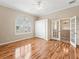 Bedroom with wood floors, large window, and French doors at 12205 Se 174Th Pl, Summerfield, FL 34491