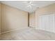 Bright bedroom with ceiling fan and double door closet. Neutral colored walls and carpeted floor at 12205 Se 174Th Pl, Summerfield, FL 34491