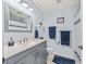 Clean bathroom with gray vanity and shower/tub combo at 1522 Yucatan Way, The Villages, FL 32159