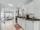 Bright kitchen featuring white cabinets and granite countertops at 1522 Yucatan Way, The Villages, FL 32159