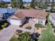 One-story house with brown roof, white garage door, and landscaped yard at 16914 Se 96Th Chapelwood Cir, The Villages, FL 32162