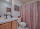 Clean bathroom with shower/tub combo and wood vanity at 16914 Se 96Th Chapelwood Cir, The Villages, FL 32162
