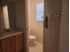 Standard bathroom featuring a single sink vanity, toilet, and a towel rack for added convenience at 16914 Se 96Th Chapelwood Cir, The Villages, FL 32162
