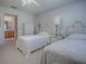 Bedroom with two twin beds, ceiling fan, and access to a full bathroom at 16914 Se 96Th Chapelwood Cir, The Villages, FL 32162