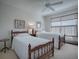 Cozy bedroom with twin beds and ceiling fan at 16914 Se 96Th Chapelwood Cir, The Villages, FL 32162