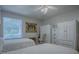 Bedroom with twin beds, white dresser, and a large window at 16914 Se 96Th Chapelwood Cir, The Villages, FL 32162
