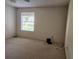 Standard bedroom featuring neutral walls, patterned carpeting, and a window offering natural light at 16914 Se 96Th Chapelwood Cir, The Villages, FL 32162
