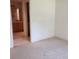 Bedroom with neutral walls, patterned carpeting, and access to an en-suite bathroom for added convenience at 16914 Se 96Th Chapelwood Cir, The Villages, FL 32162
