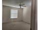 A standard bedroom with neutral colored walls, carpeted floors, window, and a ceiling fan at 16914 Se 96Th Chapelwood Cir, The Villages, FL 32162