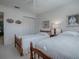 Bedroom with twin beds, wooden nightstands, and a ceiling fan at 16914 Se 96Th Chapelwood Cir, The Villages, FL 32162