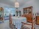 Dining room with wooden table, chairs, and a china cabinet at 16914 Se 96Th Chapelwood Cir, The Villages, FL 32162