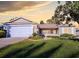 Tan single story home with two car garage and porch at 16914 Se 96Th Chapelwood Cir, The Villages, FL 32162
