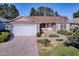 Single-story home with a paved driveway and landscaped front yard at 16914 Se 96Th Chapelwood Cir, The Villages, FL 32162