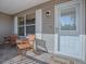 Front porch with two wooden chairs and a welcome mat at 16914 Se 96Th Chapelwood Cir, The Villages, FL 32162