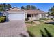 Front yard view of house with double garage and landscaping at 16914 Se 96Th Chapelwood Cir, The Villages, FL 32162