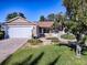 Front yard view of house with double garage and landscaping at 16914 Se 96Th Chapelwood Cir, The Villages, FL 32162