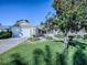Front yard view of house with double garage and landscaping at 16914 Se 96Th Chapelwood Cir, The Villages, FL 32162