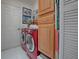 Laundry room with washer, dryer, and built-in cabinetry at 16914 Se 96Th Chapelwood Cir, The Villages, FL 32162