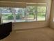 Bright and airy living space featuring large windows offering serene views of the outdoors at 16914 Se 96Th Chapelwood Cir, The Villages, FL 32162