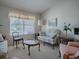 Bright living room with comfy seating and a large window at 16914 Se 96Th Chapelwood Cir, The Villages, FL 32162