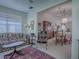 Bright living room featuring a floral sofa and antique furniture at 16914 Se 96Th Chapelwood Cir, The Villages, FL 32162