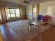 Living room with wood-look flooring, neutral carpet, and two accent chairs at 2060 Brookside Dr, Mount Dora, FL 32757